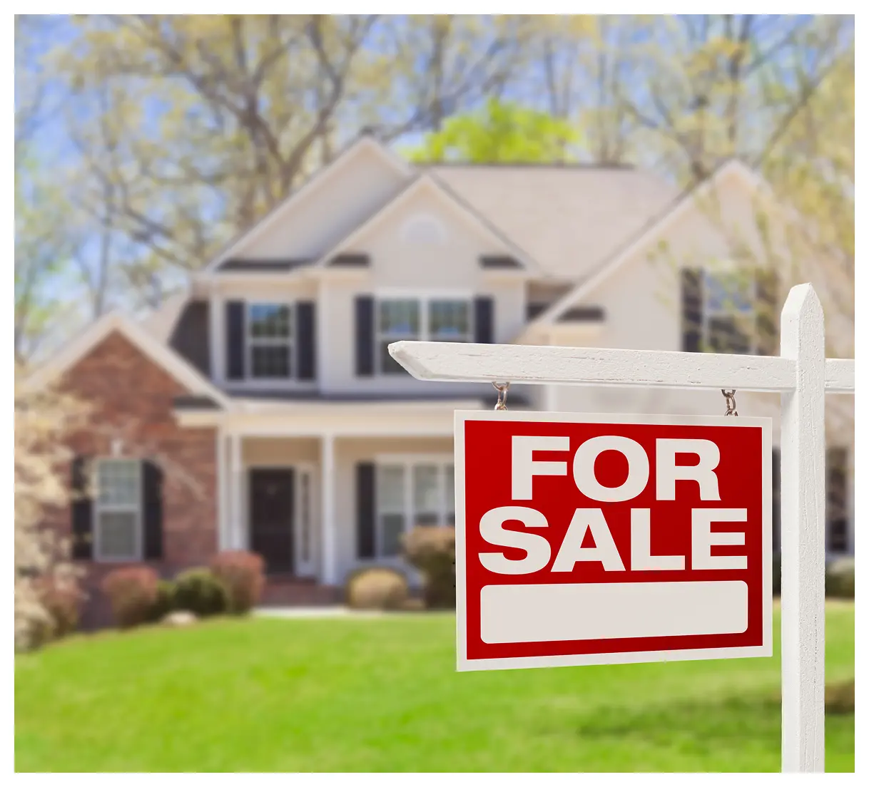 A house with a 'For Sale' sign in the front yard.